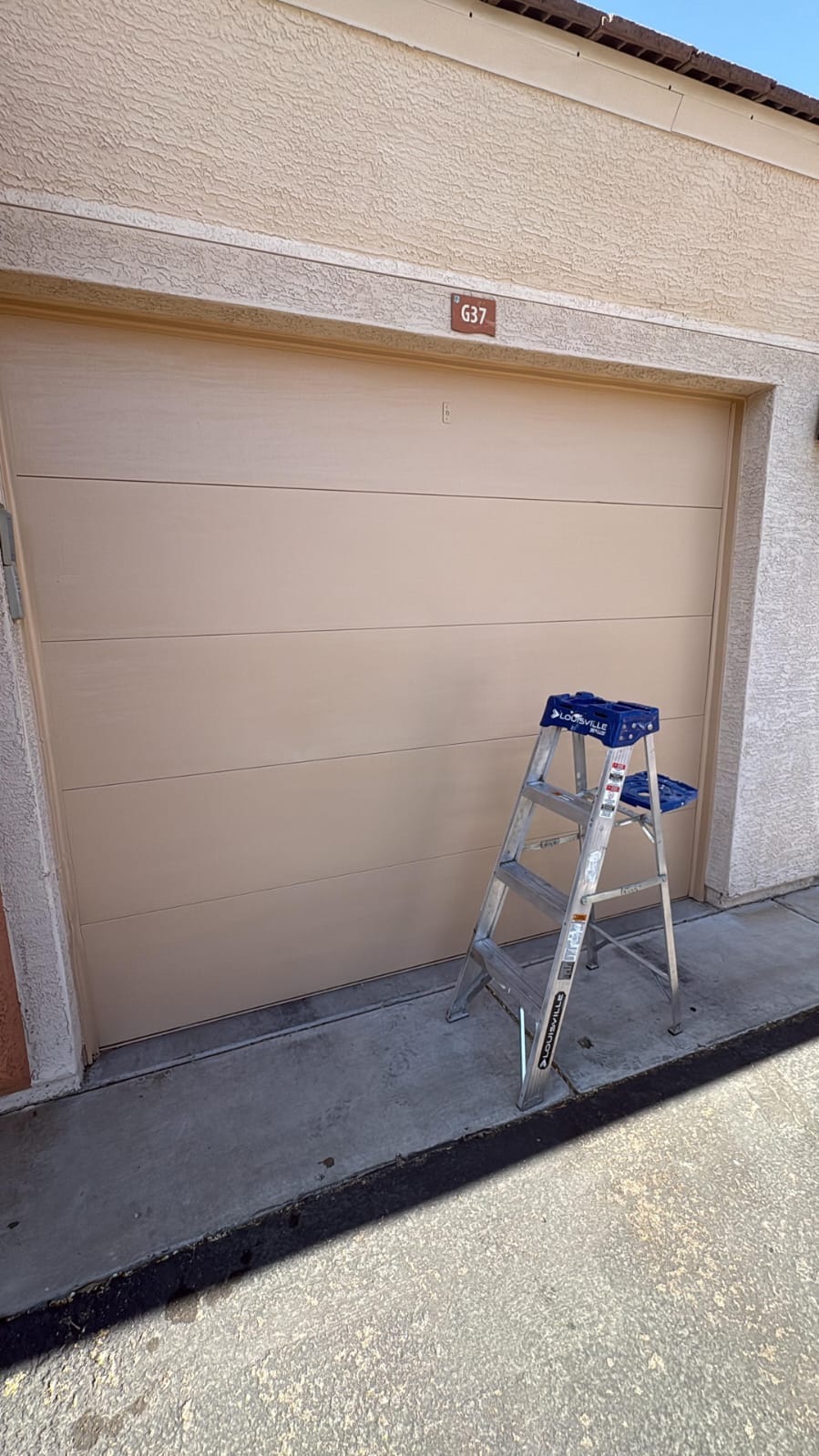 New tan garage door installed on an Arizona stucco home in Goodyear.