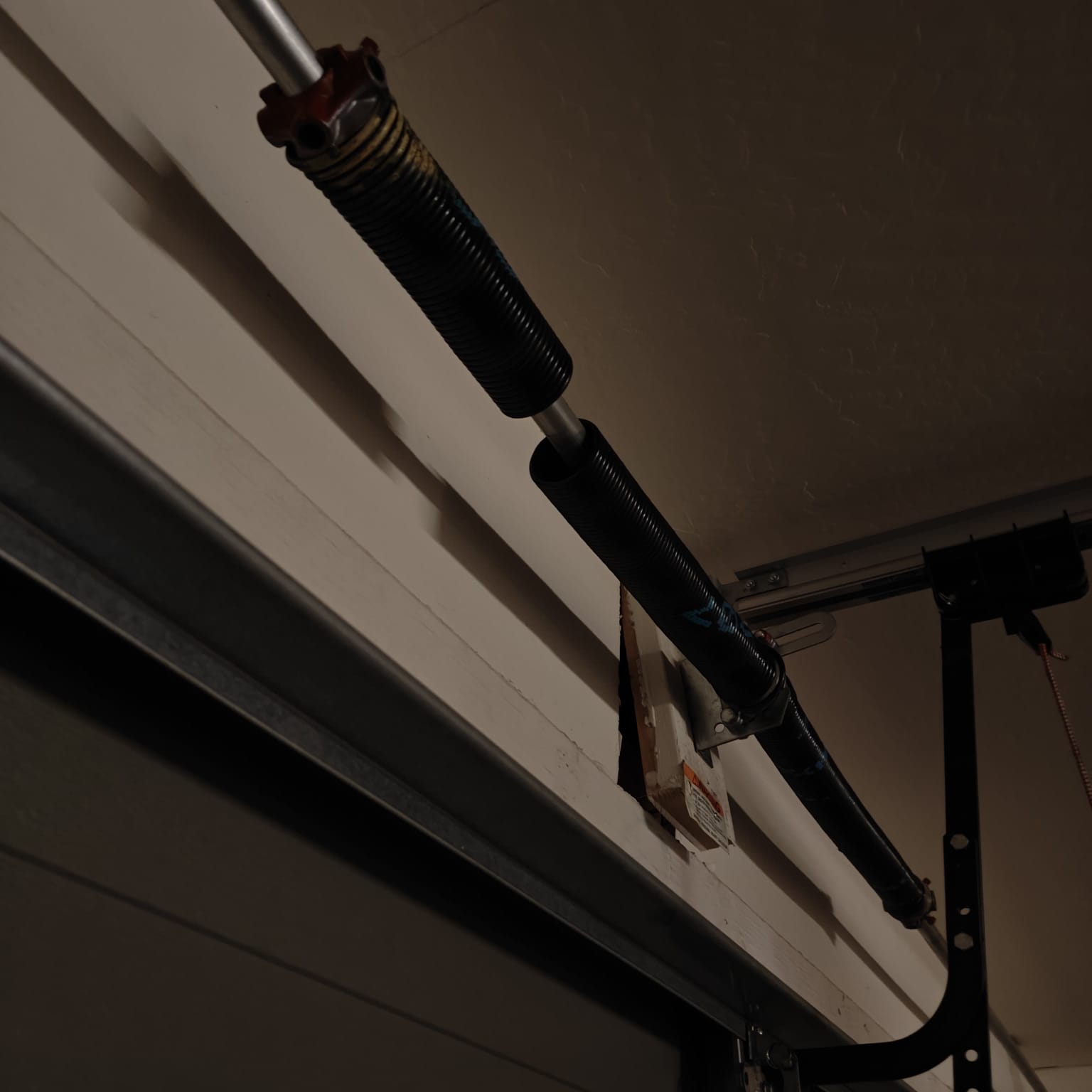 A snapped garage door torsion spring we replaced on a Goodyear job.